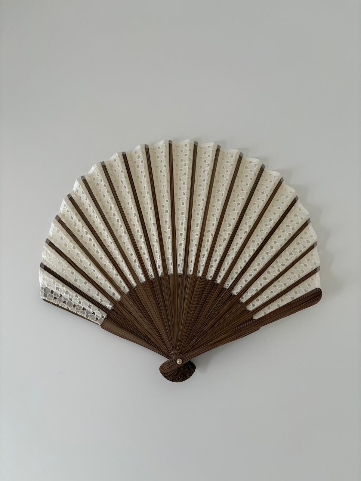 White lace folding fan with dark wooden ribs