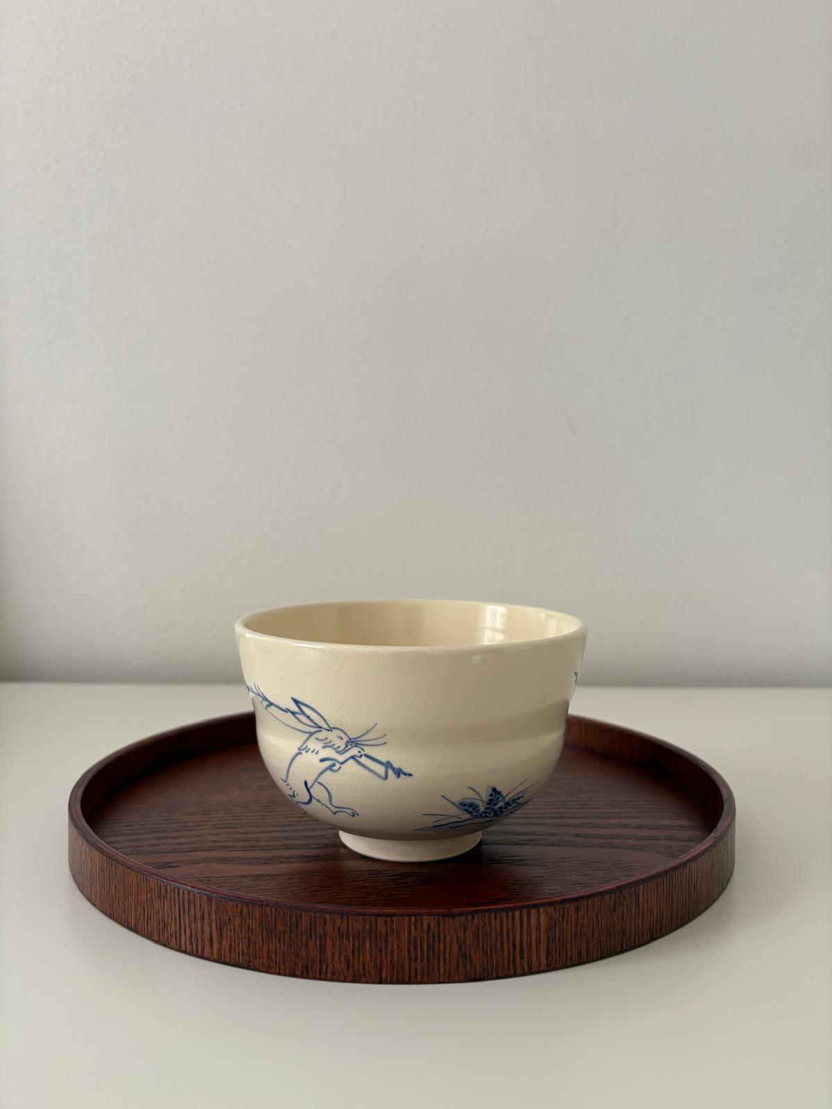 Japanese tea bowl on a dark wooden tray
